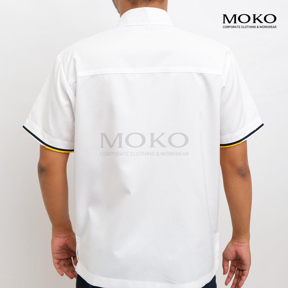 Back view of a man wearing a white short-sleeved corporate work shirt with yellow and blue trim.